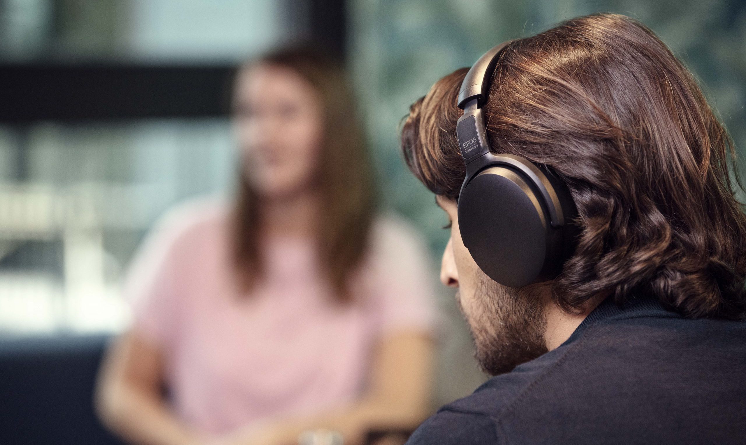 Man using headsets to concentrate in busy area