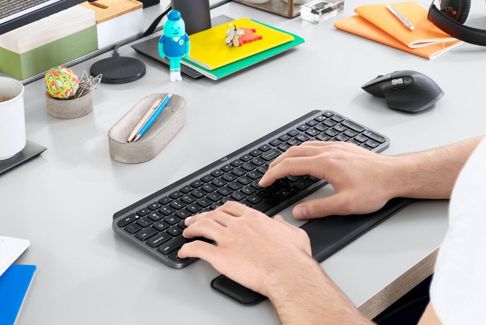 man working at his desk using a keyboard