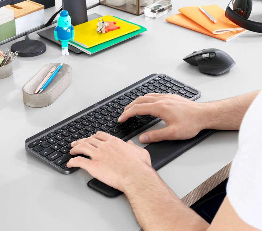 man working at his desk using a keyboard