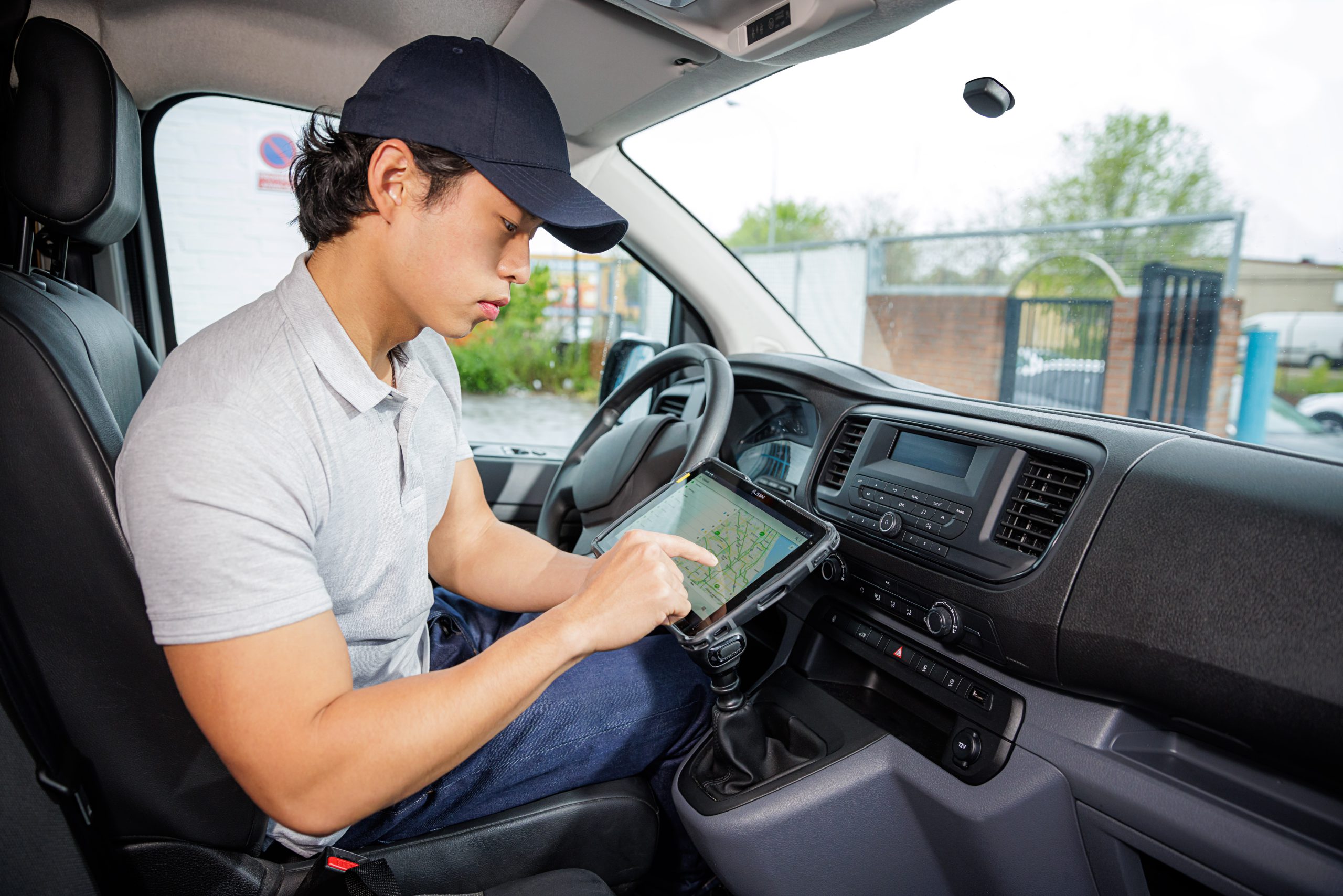 man using a tablet in a van